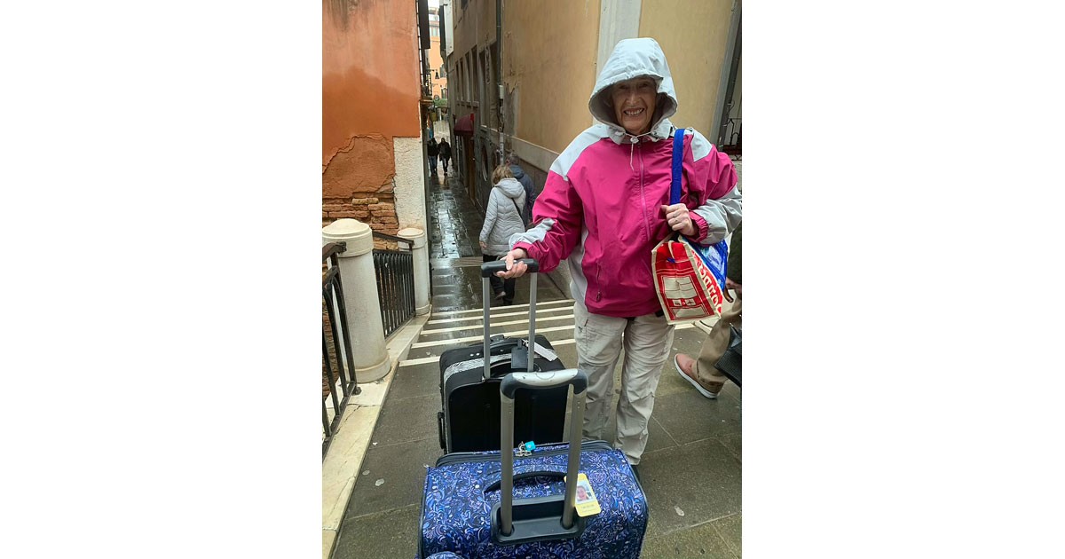 Dragging luggage across a bridge in Venice - Elsa Dixon